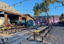 Where to Happy Hour in the East End An outdoor patio on a sunny day with string lights overhead