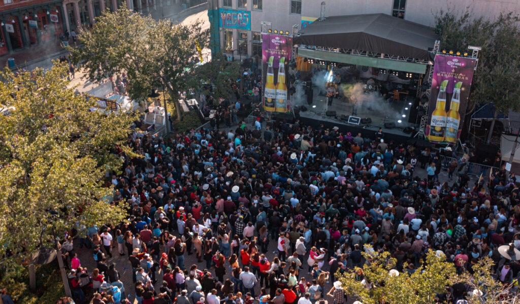 An aerial view of a concert with crowds and a stage