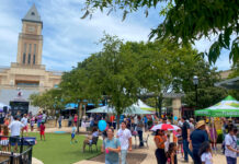 5 Must Do Things in Greater Katy A market scene with people walking between stalls