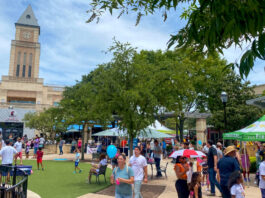 A market scene with people walking between stalls