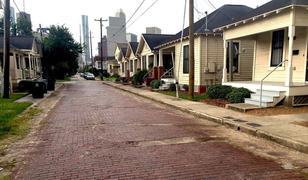 A view of a brick-laden street lined with old homes in Freedmen's Town