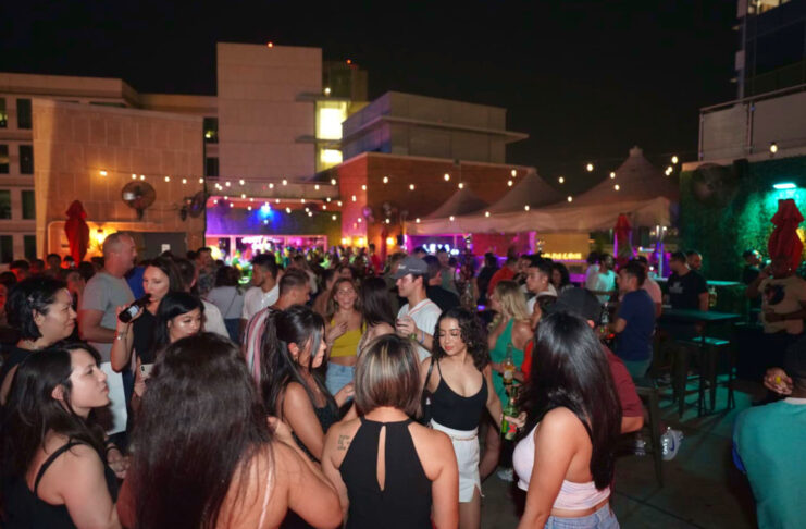 An outdoor bar area with people dancing