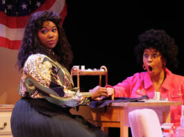 Two women react with surprise at a nail salon in an on-stage production