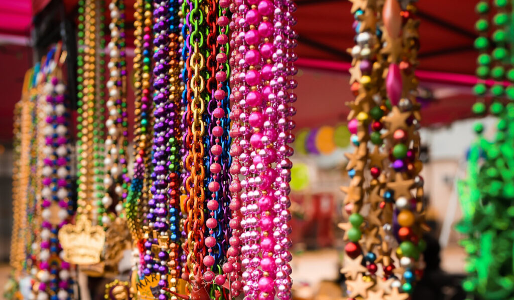 A close up of various colors of hanging beads at a vendor stall