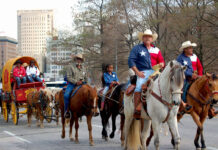 12+ Ways to Get Rodeo Ready in Houston People riding horses through a Downtown street wearing Texas flag shirts