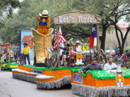 A green and orange parade float with a boot and Rodeo mascot
