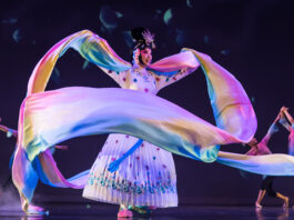 A dancer in cultural regalia performs on stage for Lunar New Year