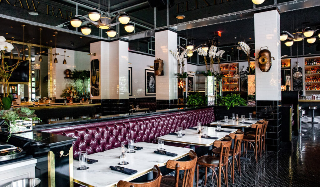 A bar interior with plush purple seating and white tile decor