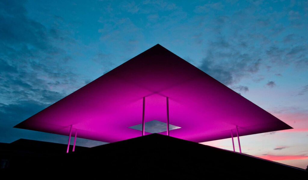 A view of the "Twilight Epiphany" installation lit purple at sunset