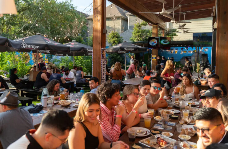 Groups of people sitting at the back patio of King's Bierhaus