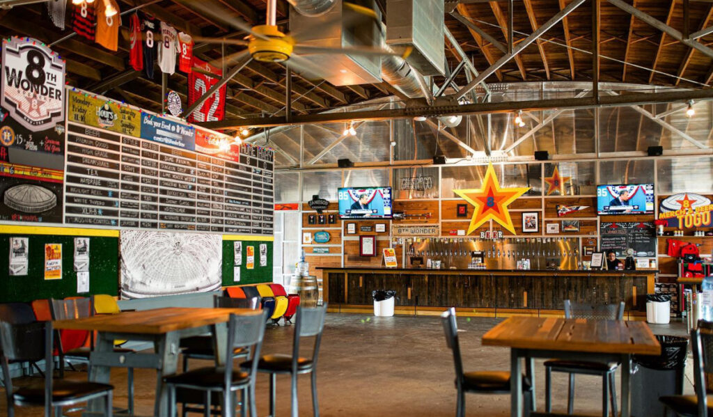 The 8th Wonder taproom with Houston-themed decor and sports jerseys