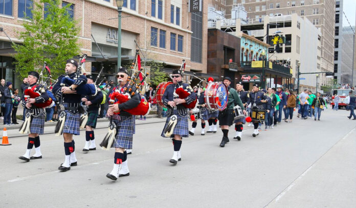 Rows of bagpipers parade down the streets