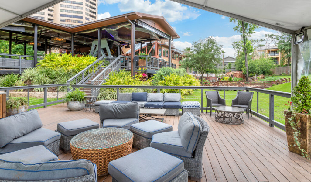 An outdoor patio with a circle of seating and stairs leading to a restaurant