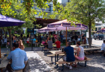 Where to Brunch near Washington Avenue & Memorial Park A shaded outdoor patio filled with patrons during the daytime