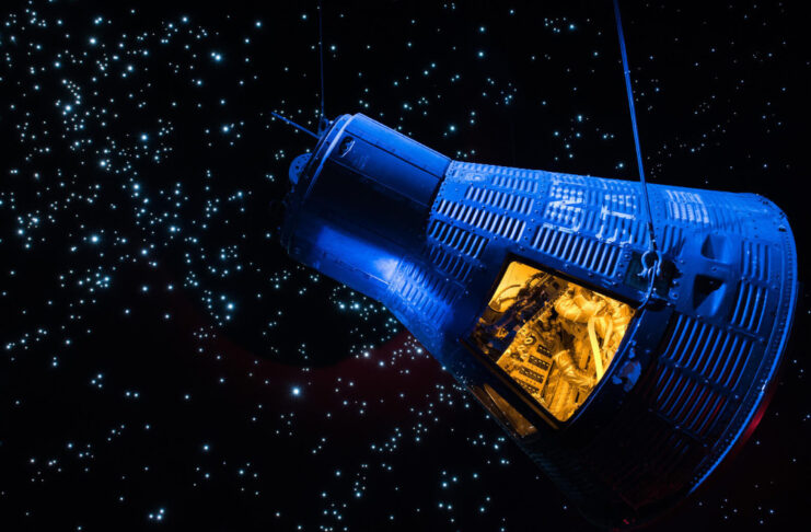 A exhibit display of a Gemini capsule floating in space