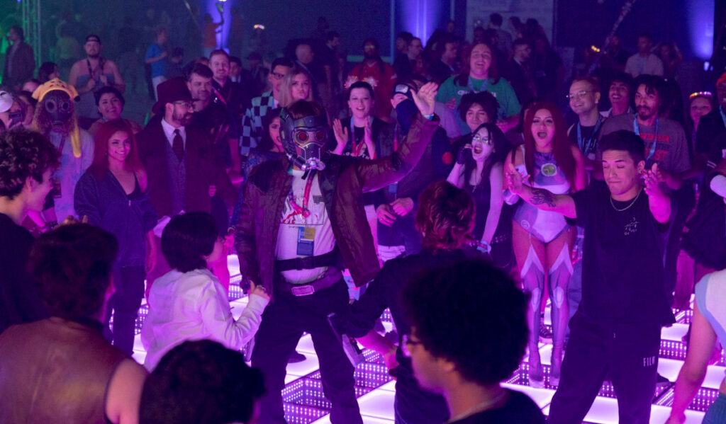 A dance floor filled with people wearing pop culture costumes