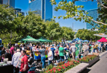 Where to Celebrate Earth Day in Greater Houston A bustling market scene with people moving past booths