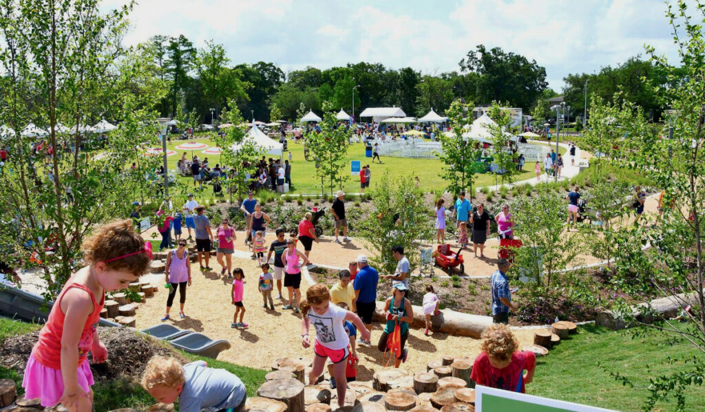 Kids climbing uphill in an expansive park space