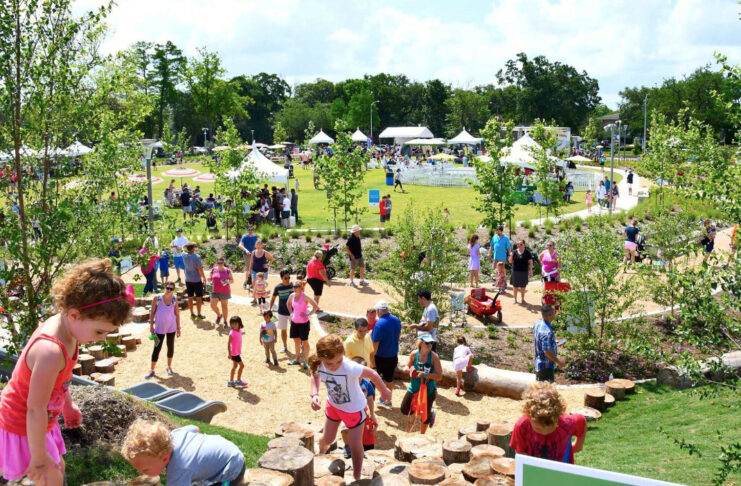 Kids climbing uphill in an expansive park space