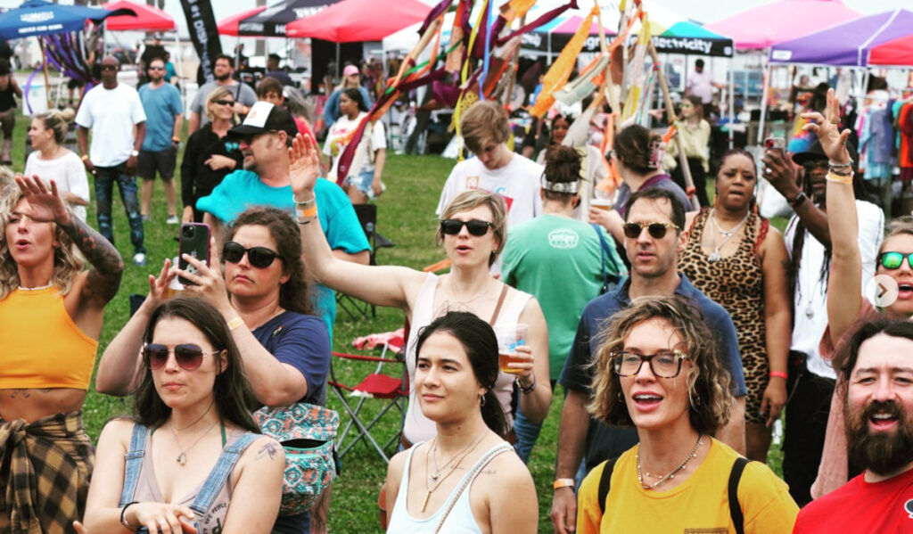 A crowd of festival goers dancing to music