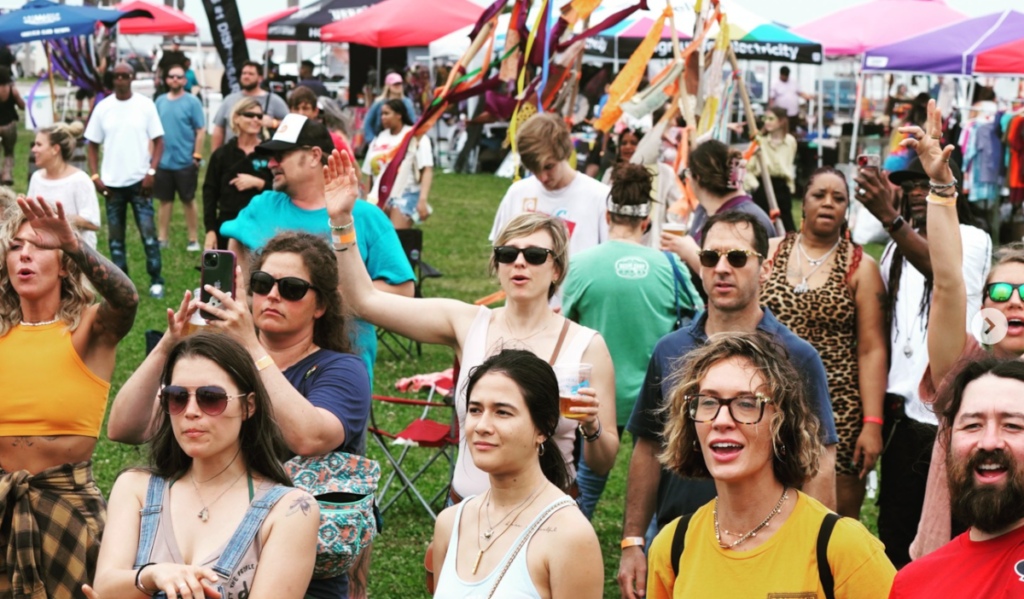 A crowd of festival goers dancing to music