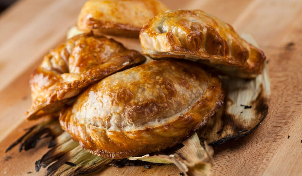 A close up of four empanadas piled on one another