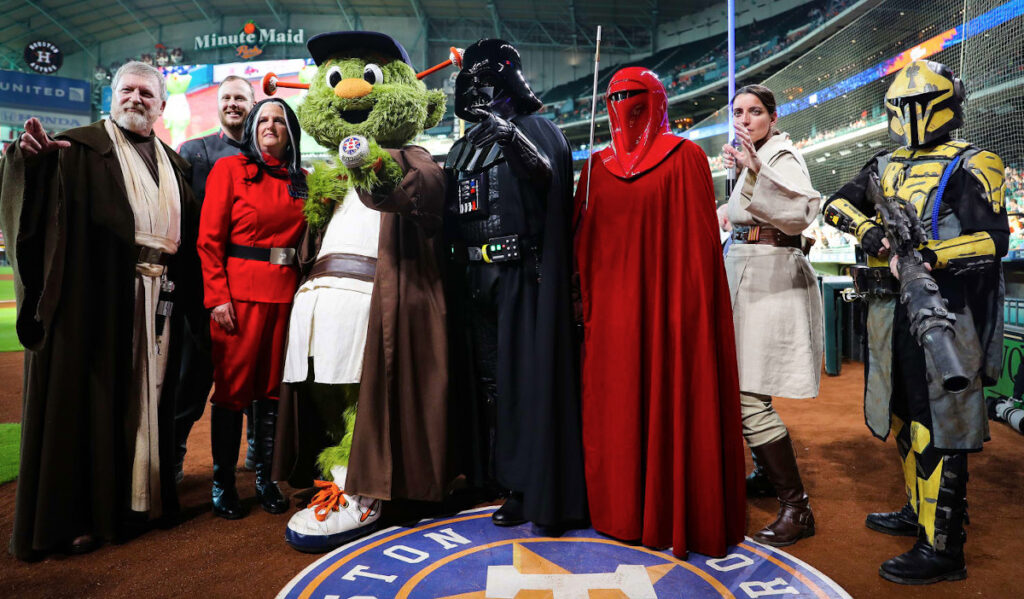 Astros mascot Orbit and Star Wars characters pose on the field before a game