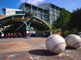 Fans waiting outside the Minute Maid Park gates below an arch that says "Center Field"