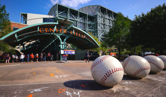 Fans waiting outside the Minute Maid Park gates below an arch that says "Center Field"