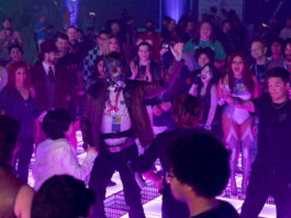 A dance floor filled with people wearing pop culture costumes