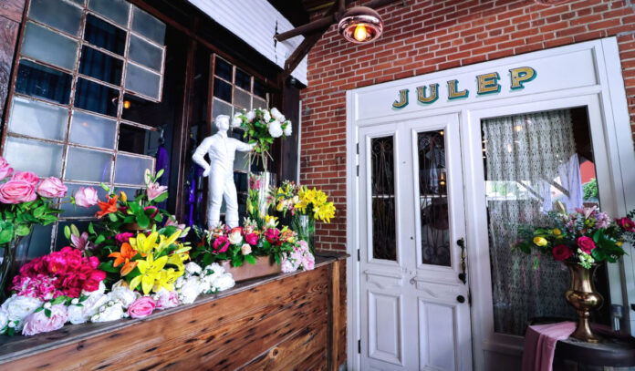 Entrance to Julep with a flower spray and jockey statue