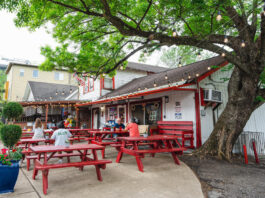 An exterior of Lankford's Grocery with red picnic tables