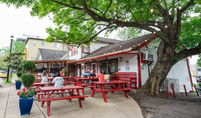 An exterior of Lankford's Grocery with red picnic tables