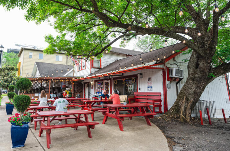 An exterior of Lankford's Grocery with red picnic tables