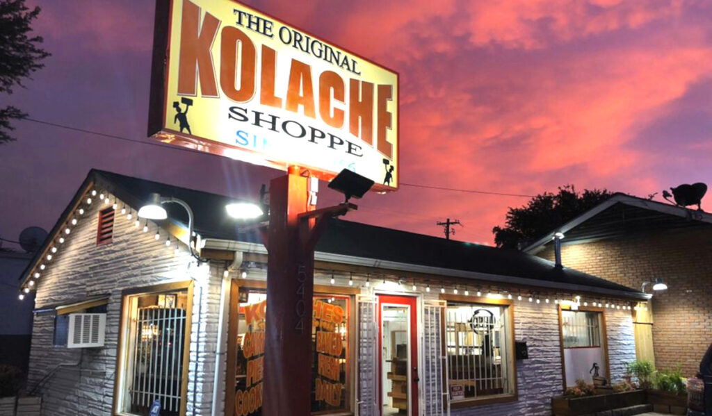 Exterior of Original Kolache Shoppe during a purple and orange sunrise