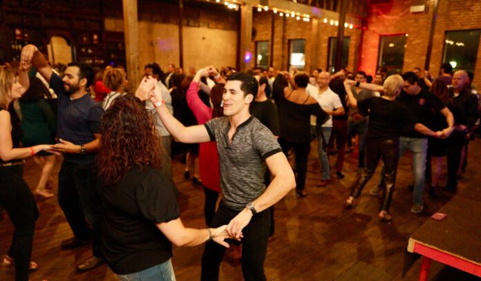 Pairs of people dancing on a dancefloor