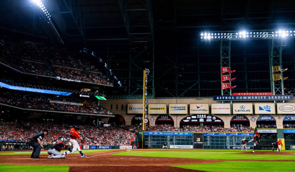 A wide view of MInute Maid Park's left field while Jake Myers hits a baseball 