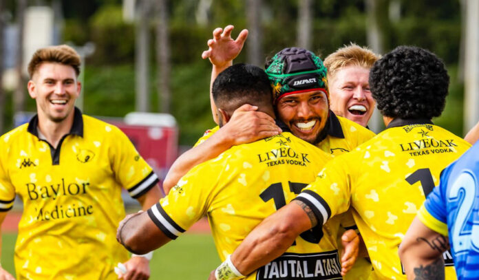 Members of the SaberCats rugby team smile and embrace